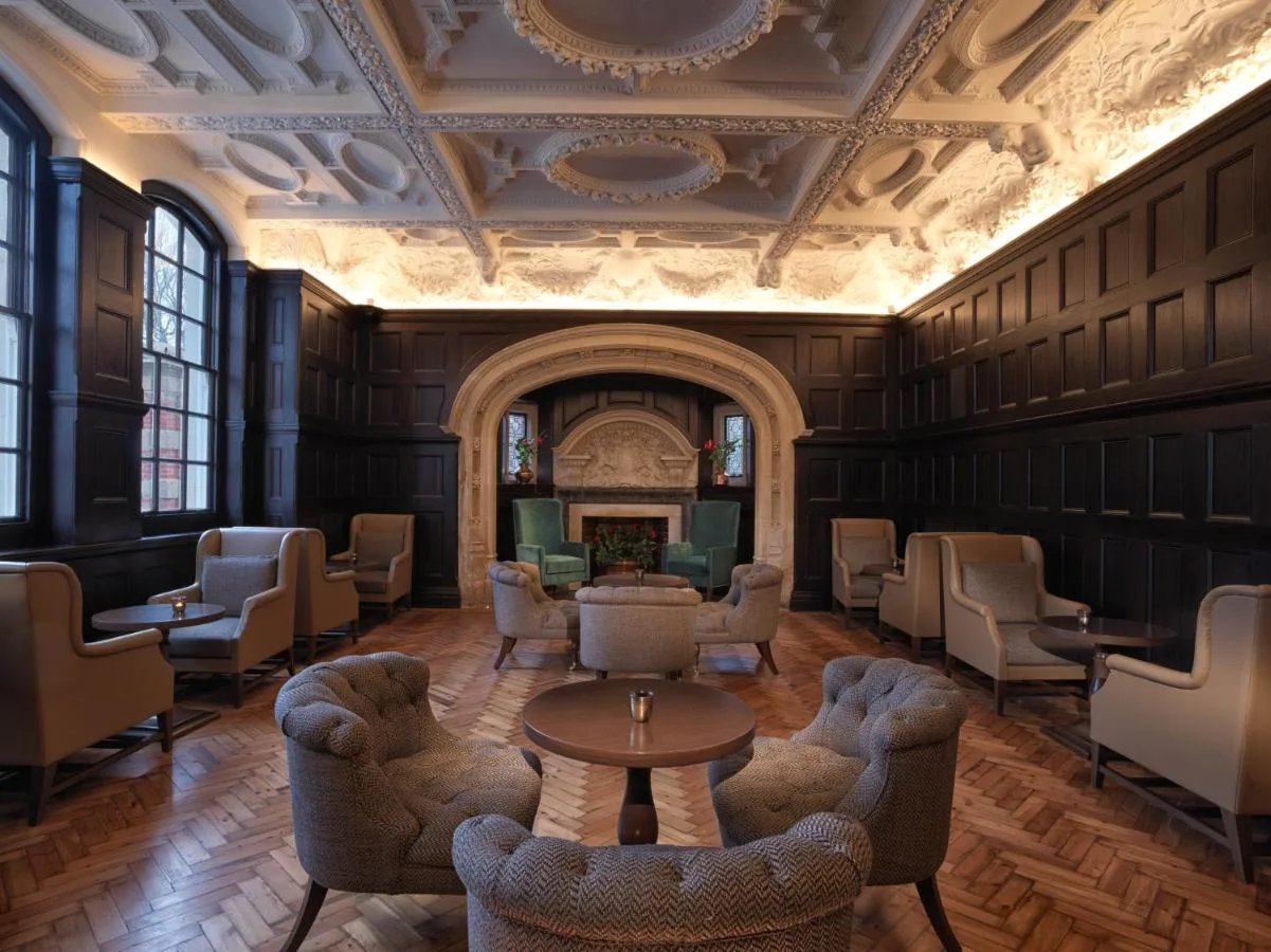 Seating area with chairs and table inside The LaLit London on Tooley Street