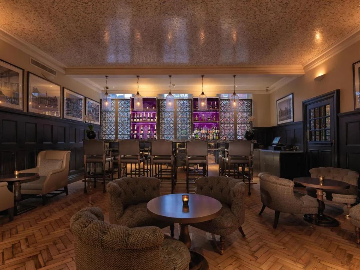 Restaurant interior with tables, chairs and bar at The LaLit London