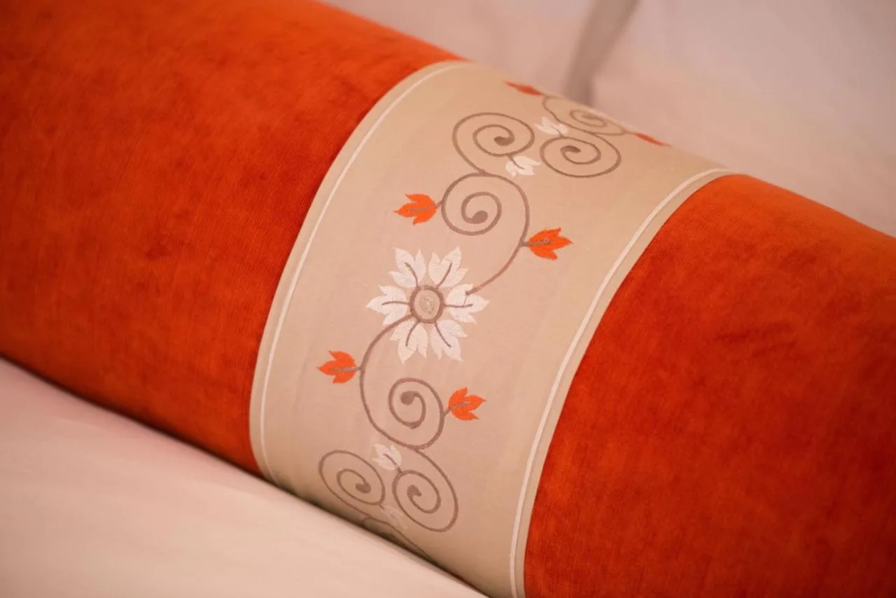 Decorative pillow detail in a guest room at The LaLit London